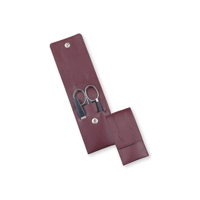 Manicure Set with Burgundy Leather Case Image of a compact manicure set with scissors, nail file, and tweezers in a burgundy leather case with snap closure.